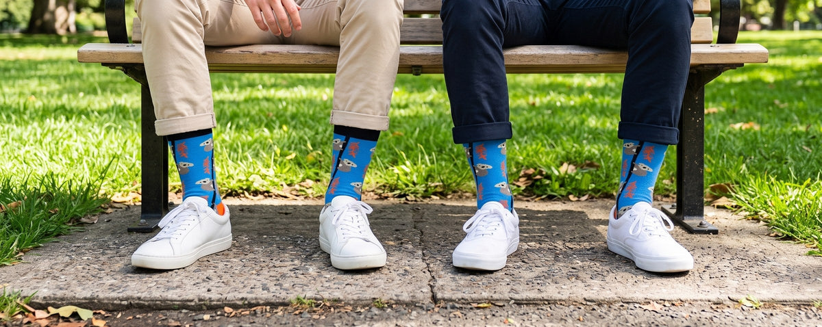 Men wearing Love Sock Company Koala organic cotton crew socks with white sneakers on a park bench