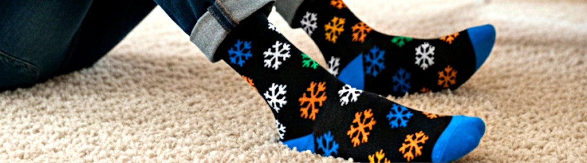 Snowflake Christmas socks on a cozy rug, Love Sock Company