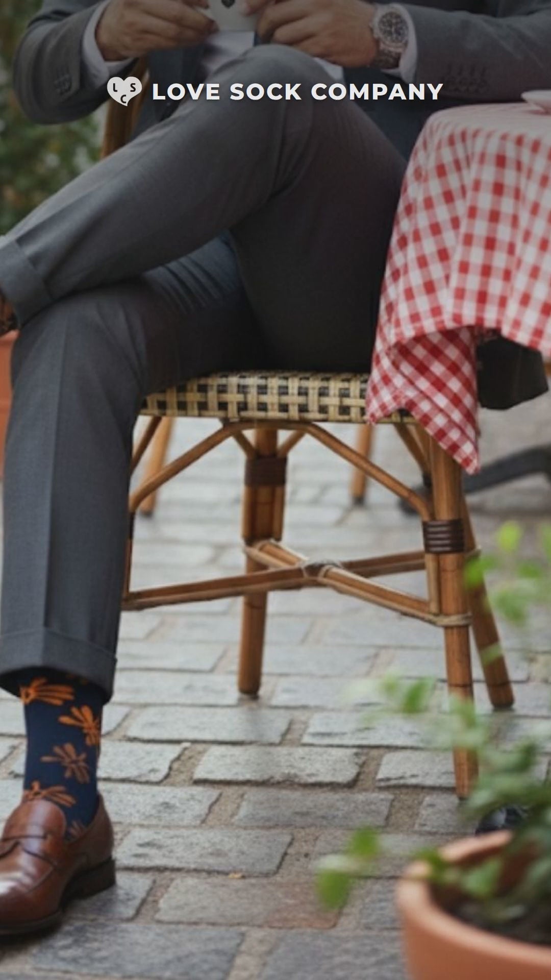 Close-up video of Love Sock Company Flowers Navy men's mid-calf dress socks, organic cotton
